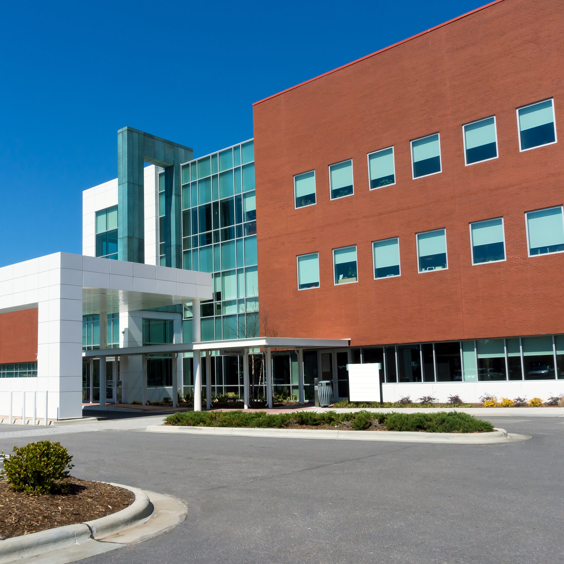 Modern medical center building exterior with driveway